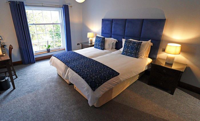 Lena room is a superior room in the Morgans Townhouse which can be twinned. Image shows the spacious bedroom with a twin-bed, ample lighting from the